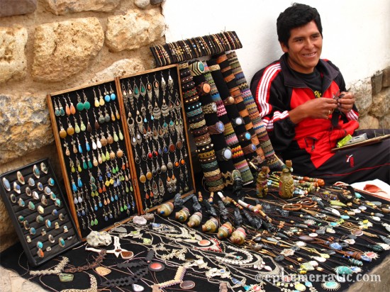 Making bespoke jewelry on the street, Cusco, Peru photo