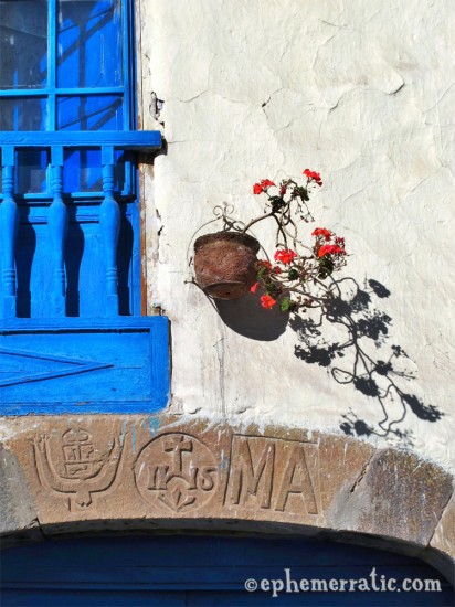 Blue window and red flowers, Cusco, Peru photo