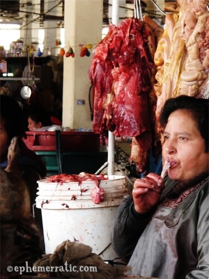 A meat vendor eats lunch in Cusco's Central Market, Peru photo