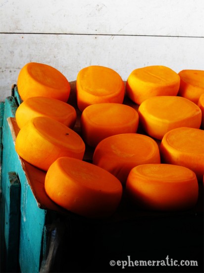 Orange wheels of cheese in Cusco's Central Market, Peru photo