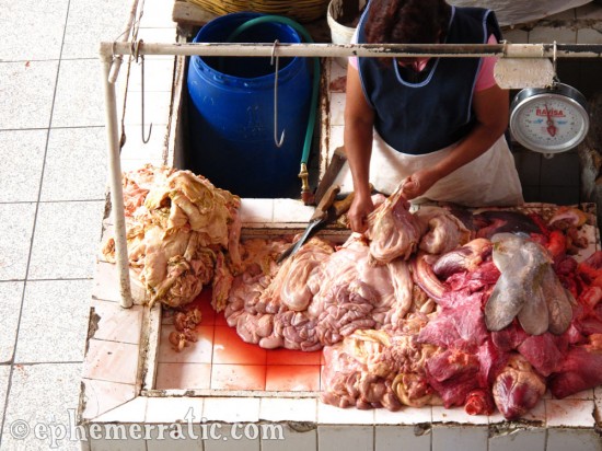 Tearing at meat parts, Mercado San Camilo, Arequipa, Peru photo