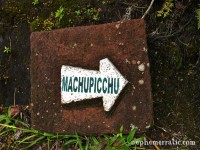 Sign with arrow pointing to Machu Picchu, Peru photo