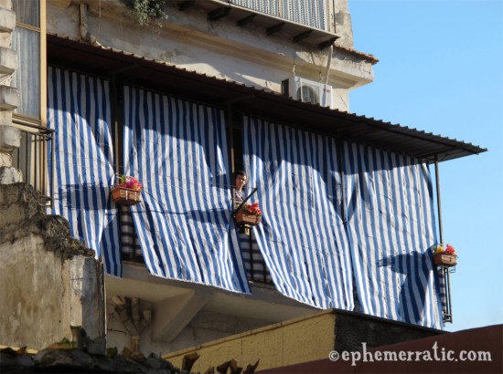 Blue striped curtains and neighbor, Palermo, Sicily, Italy photo