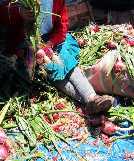 Onion seller in leg warmers, Pisac Sunday Market, Peru photo
