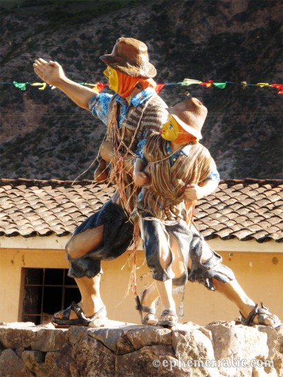 Yellow-masked statue of boy and man, Sacred Valley, Peru photo